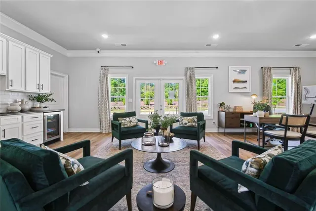 a living room with furniture kitchen and a window