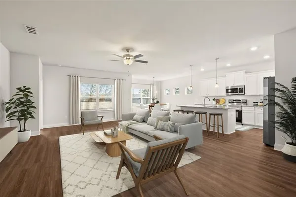 a living room with fireplace furniture and a wooden floor