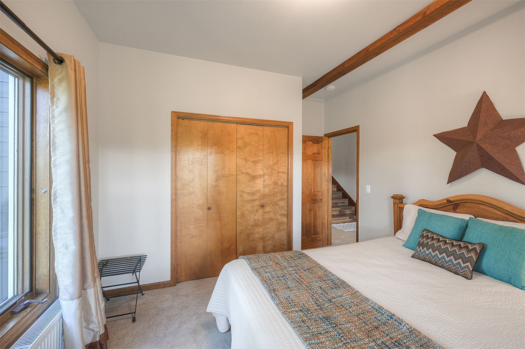 2542 Boreas Pass Road Breckenridge, CO 80424 - Photo 24 of 33 a bedroom with a bed and a dresser next to a window