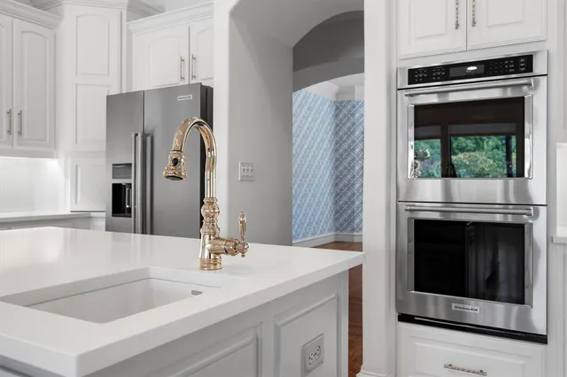 a kitchen with stainless steel appliances granite countertop a stove and a refrigerator