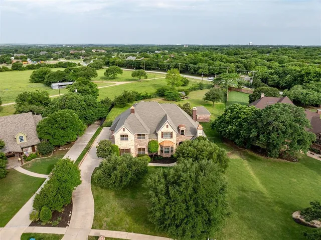 an aerial view of residential houses with outdoor space and street view