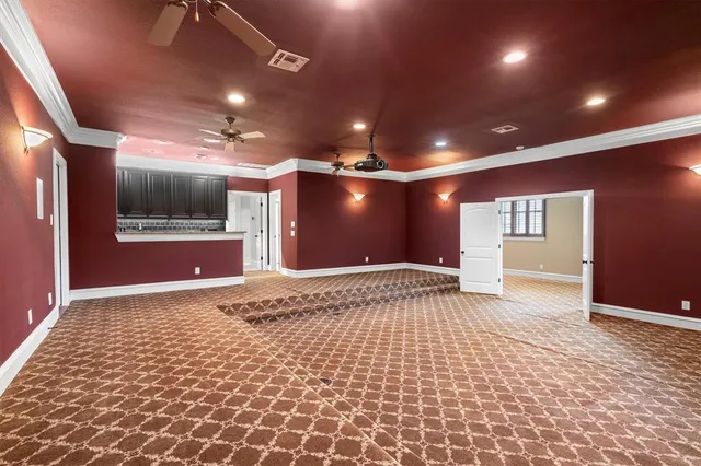 a view of hallway with a projector and a rug