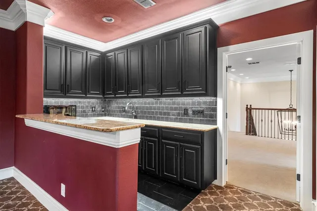 a kitchen with a sink stove and cabinets