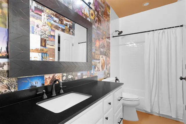 a bathroom with a sink a toilet and a mirror