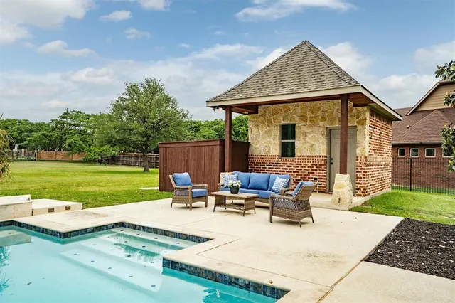 a view of a house with backyard sitting area and garden