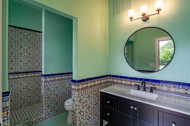 a bathroom with a sink a mirror and a shower