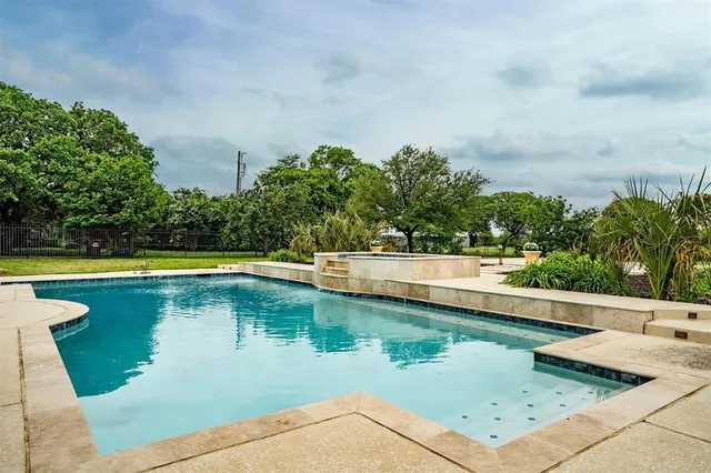 a view of a swimming pool with a yard