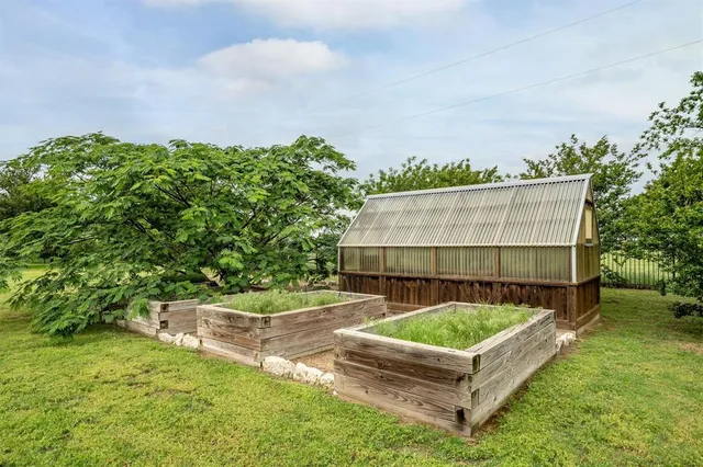 a backyard of a house with table and chairs