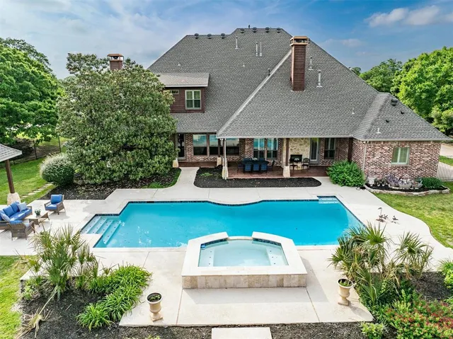 an aerial view of a house with swimming pool