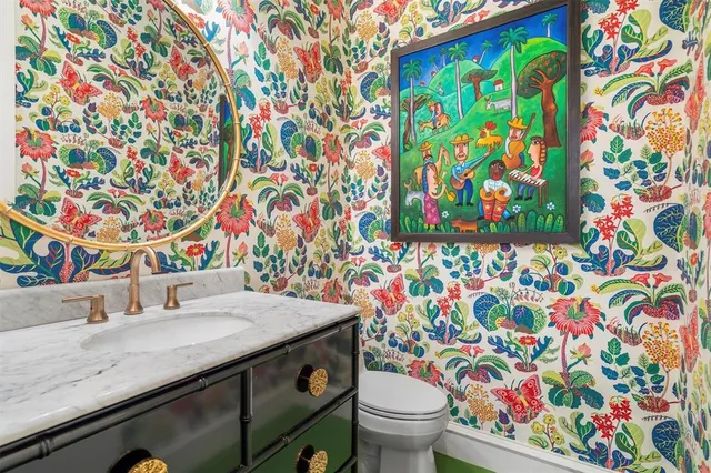 a bathroom with a sink toilet and vanity