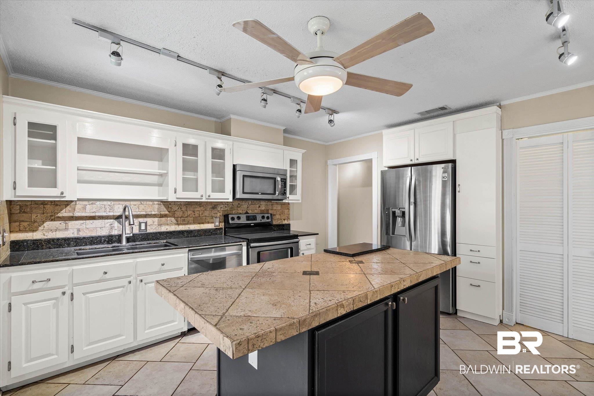 3724 Claridge Road South Mobile, AL 36608 - Photo 9 of 42 Kitchen featuring rail lighting, a kitchen island, tasteful backsplash, white cabinets, and ceiling fan