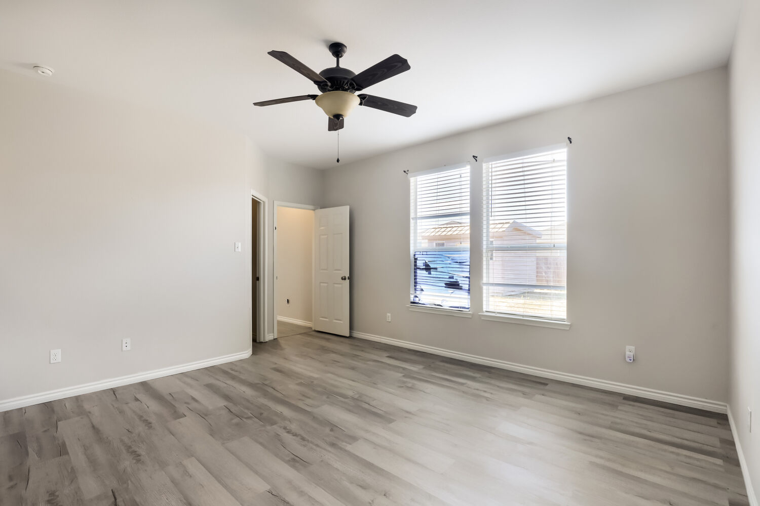 153 Marcheeta Way Leander, TX 78641 - Photo 8 of 17 Gleaming wood-look floors anchor this airy bedroom complete with generous window placement.