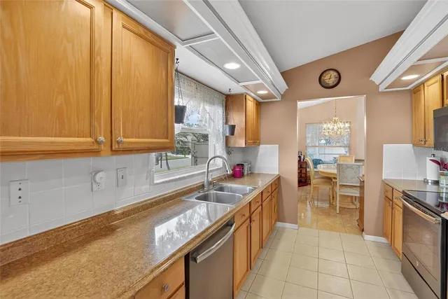 a kitchen with granite countertop a sink stove and cabinets