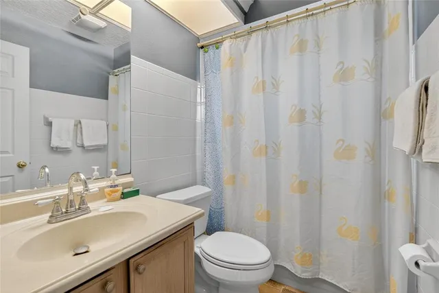 a bedroom with a bed and a flat tv screen on dresser