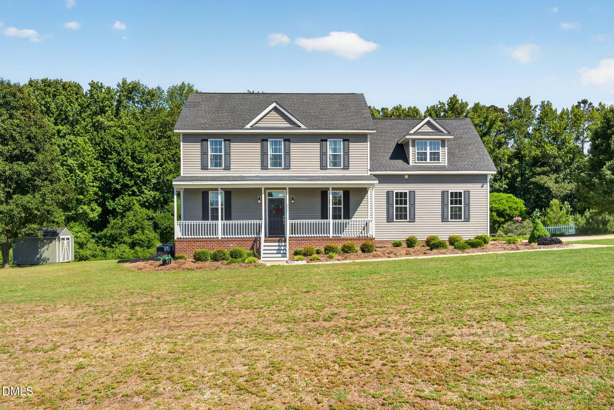 923 White Memorial Church Road Willow Spring, NC 27592 - Photo 2 of 46 a front view of a house with a garden