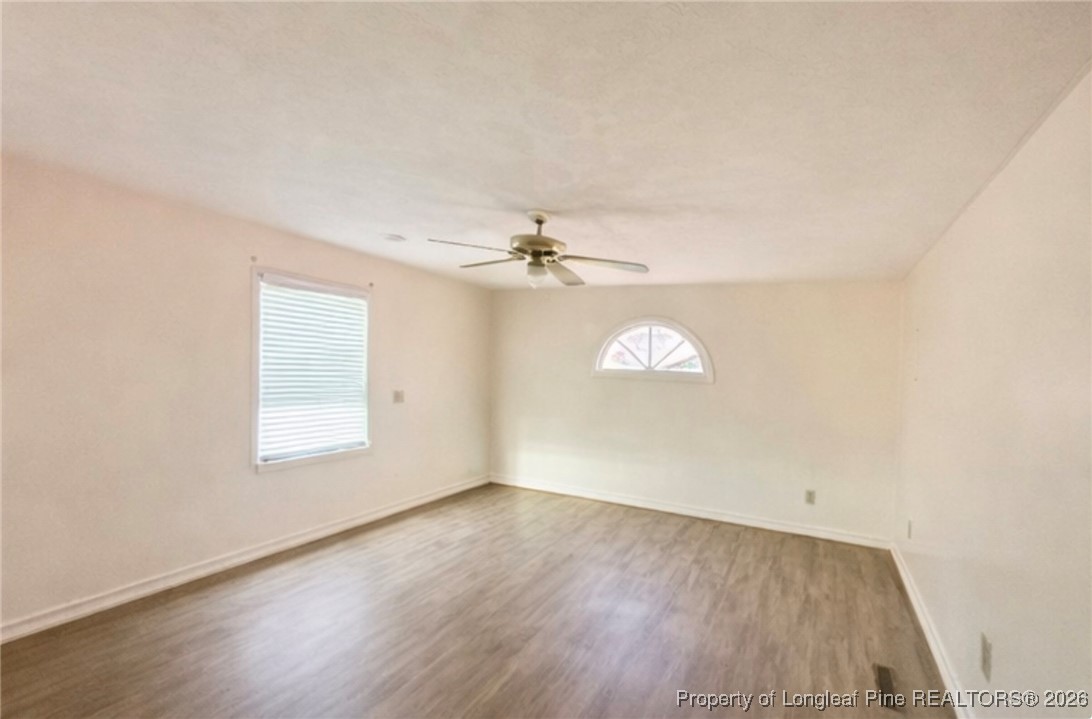 4506 Tobacco Road Orrum, NC 28369 - Photo 13 of 46 an empty room with wooden floor and windows