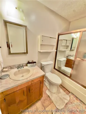 a bathroom with a tub sink and mirror