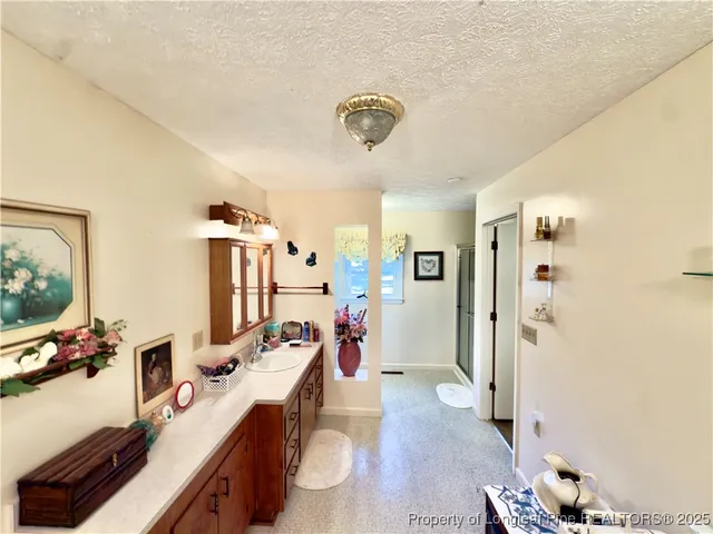 a spacious bathroom with a double vanity sink toilet and a tub