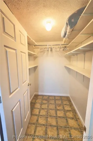 a view of an house with backyard and a tree