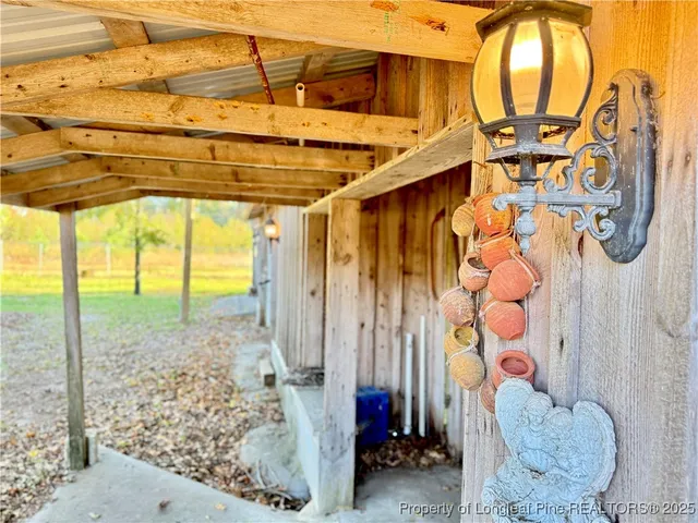a view of a house with a big yard and palm trees