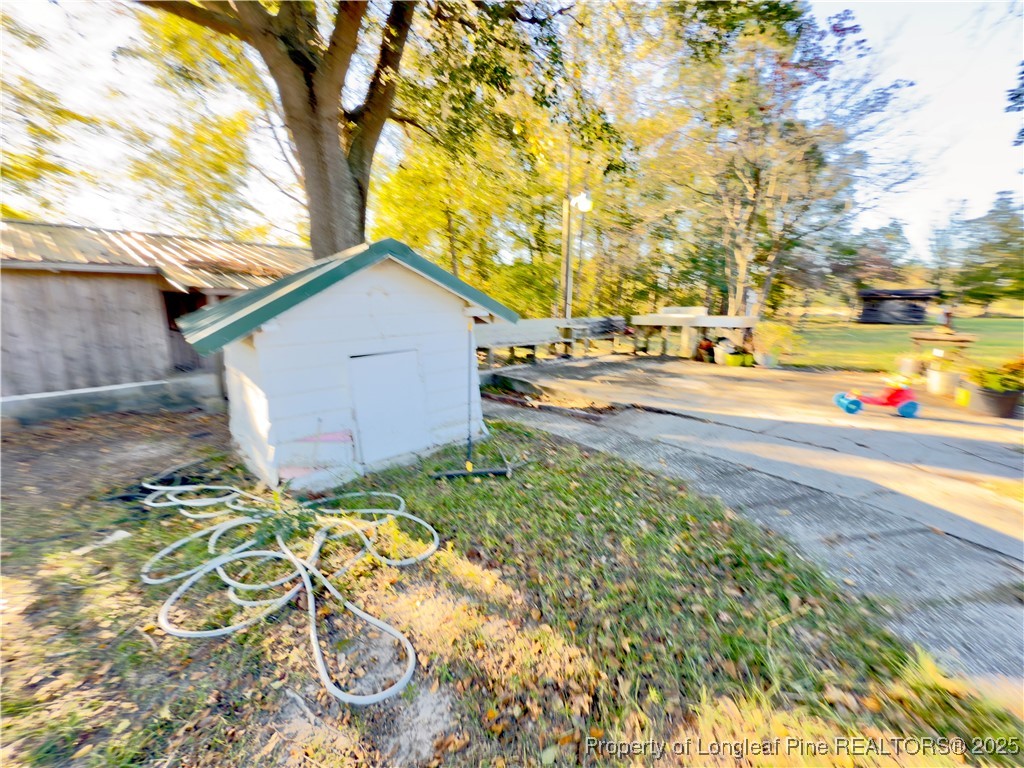 4506 Tobacco Road Orrum, NC 28369 - Photo 33 of 46 a view of an house with backyard and a tree