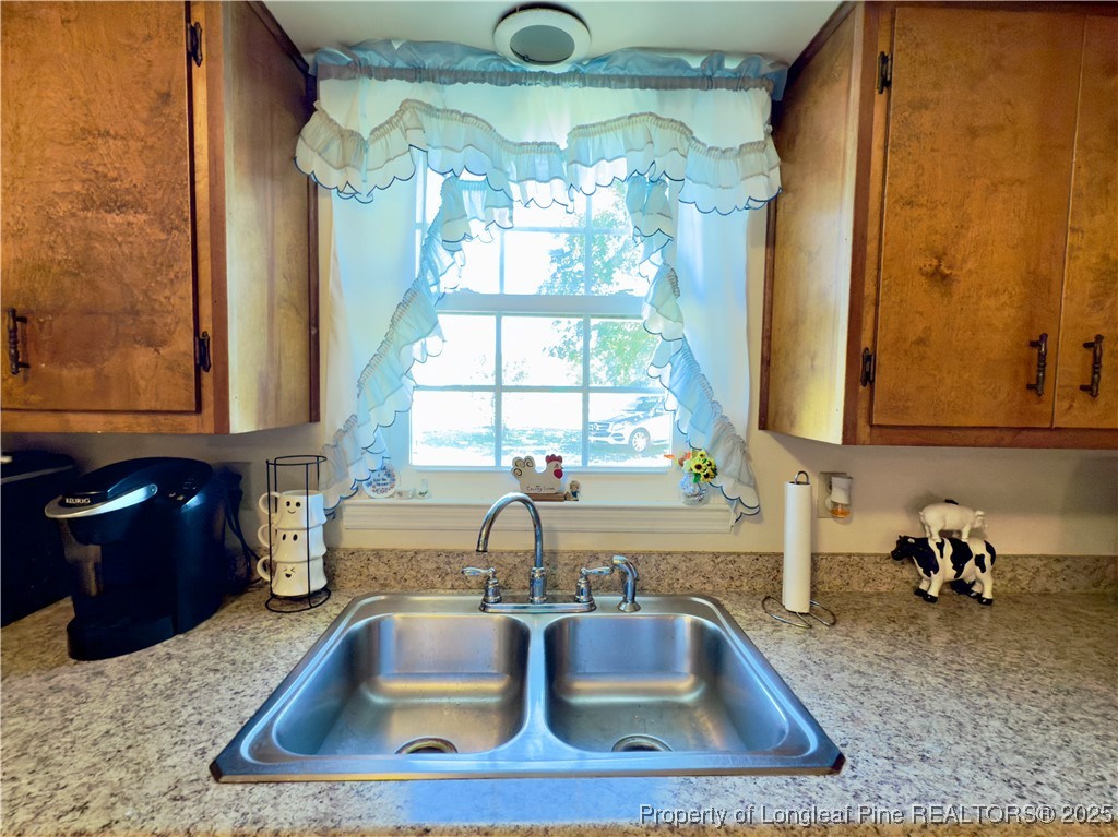 4506 Tobacco Road Orrum, NC 28369 - Photo 6 of 46 a kitchen with a sink and a window