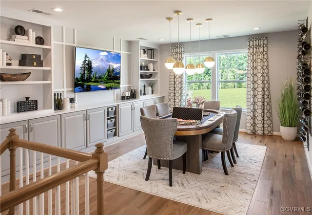 a dining room with furniture window and wooden floor