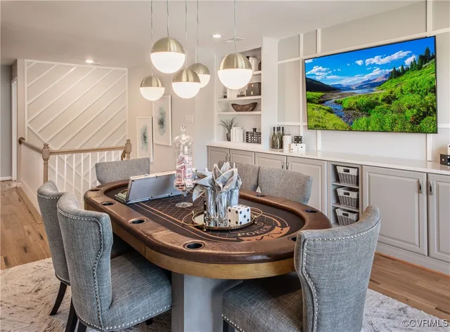 a view of a dining room with furniture a chandelier and wooden floor