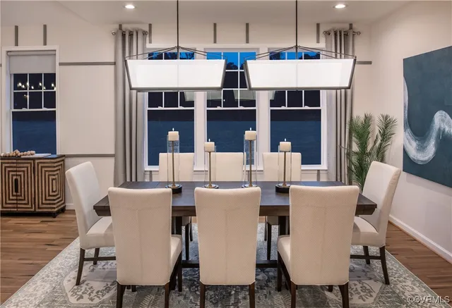 a dining room with furniture a rug and wooden floor