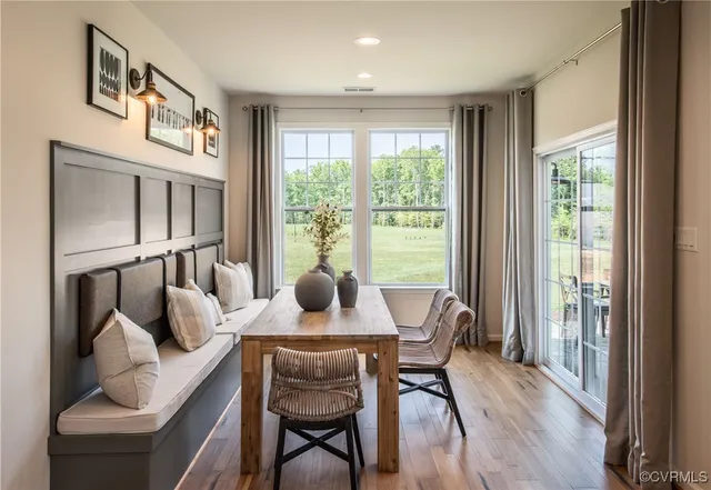 a dining room with furniture and a window