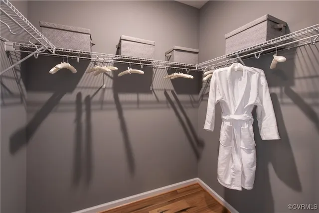 a view of walk in closet with clothes and shoes