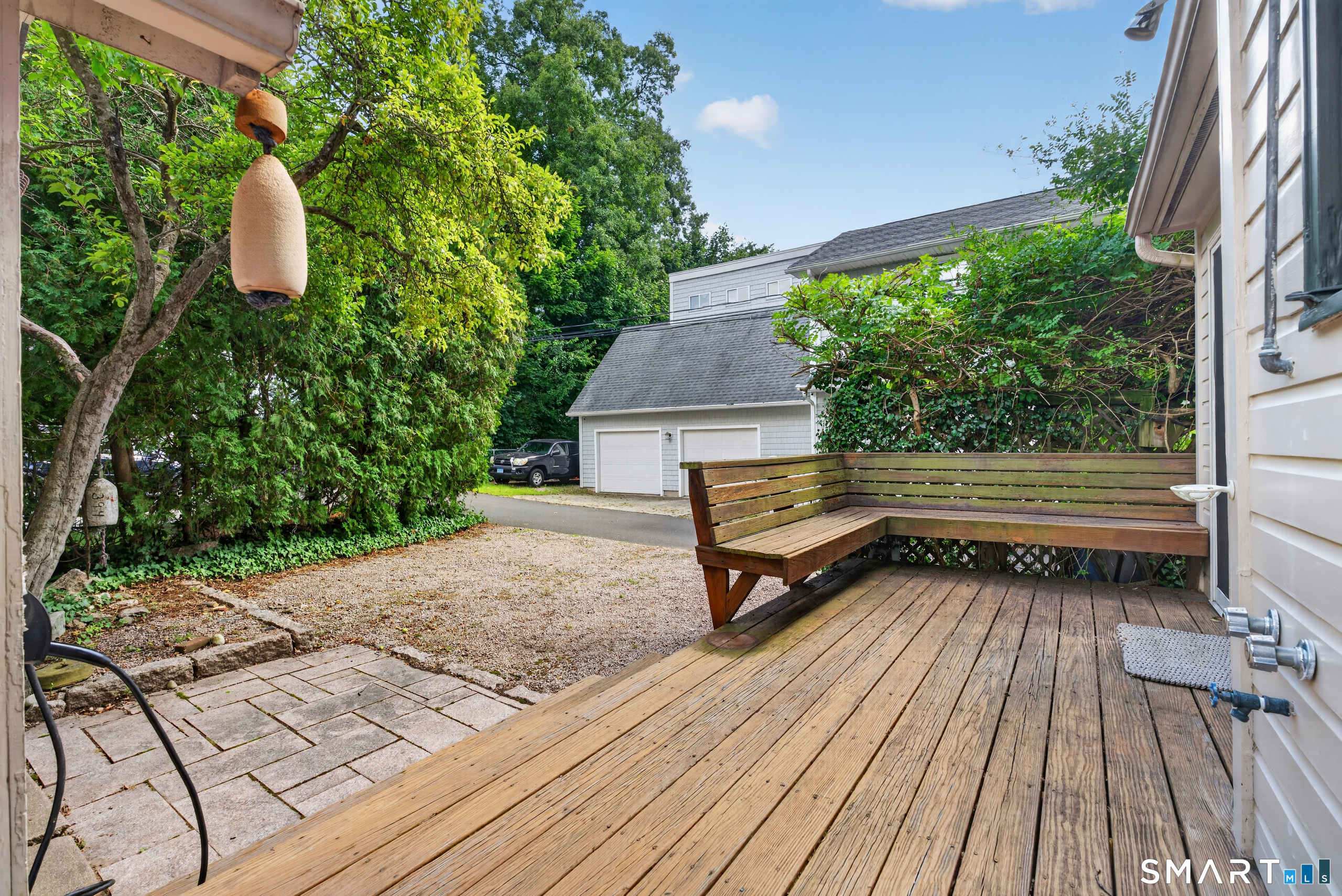 Rear porch and driveway leading to detached garage