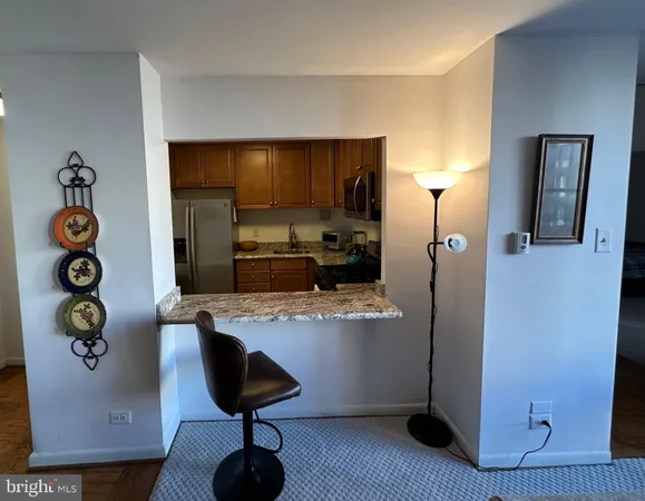 a kitchen with stainless steel appliances granite countertop a refrigerator and a stove