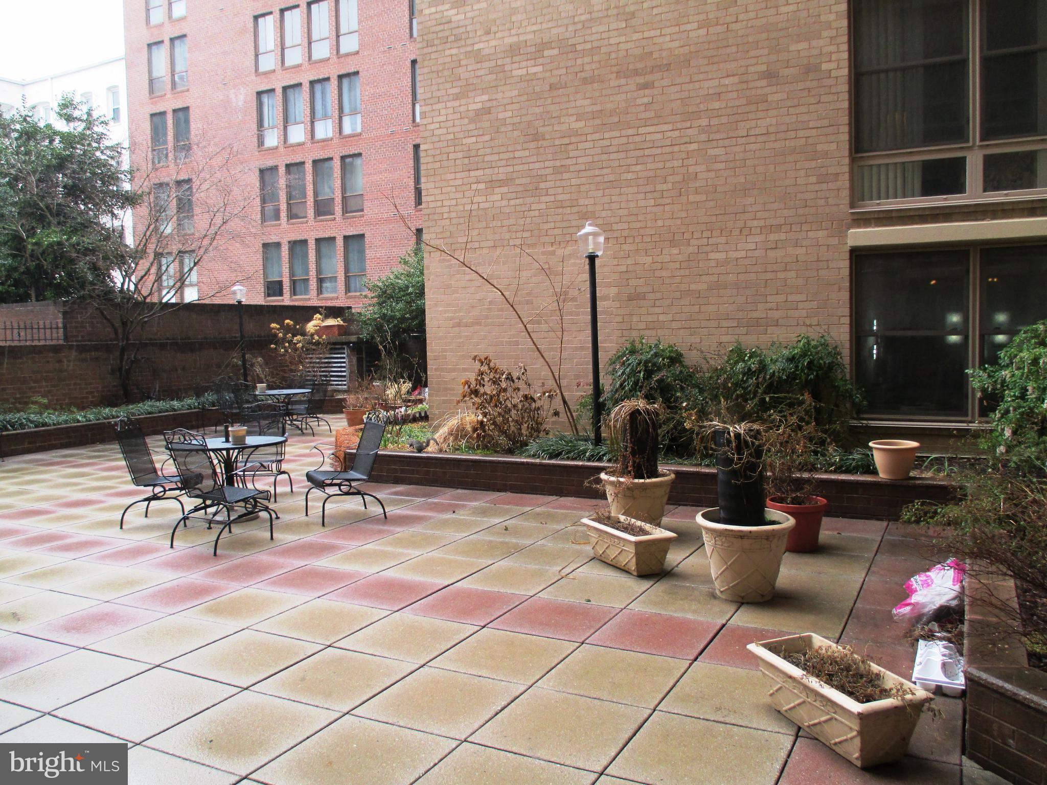 1260 21st Street Northwest, Unit 309 Washington, DC 20036 - Photo 16 of 16 a view of a patio with table and chairs and potted plants