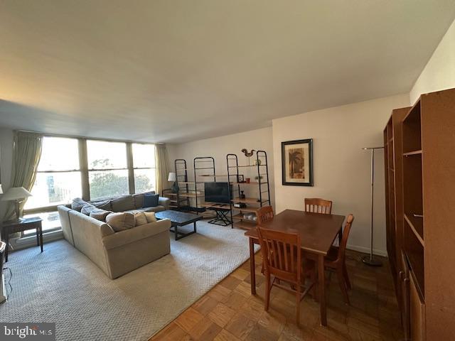 1260 21st Street Northwest, Unit 309 Washington, DC 20036 - Photo 3 of 16 a living room with furniture wooden floor and a large window