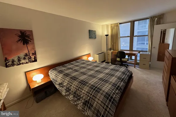 a bed sitting in a bedroom next to a window