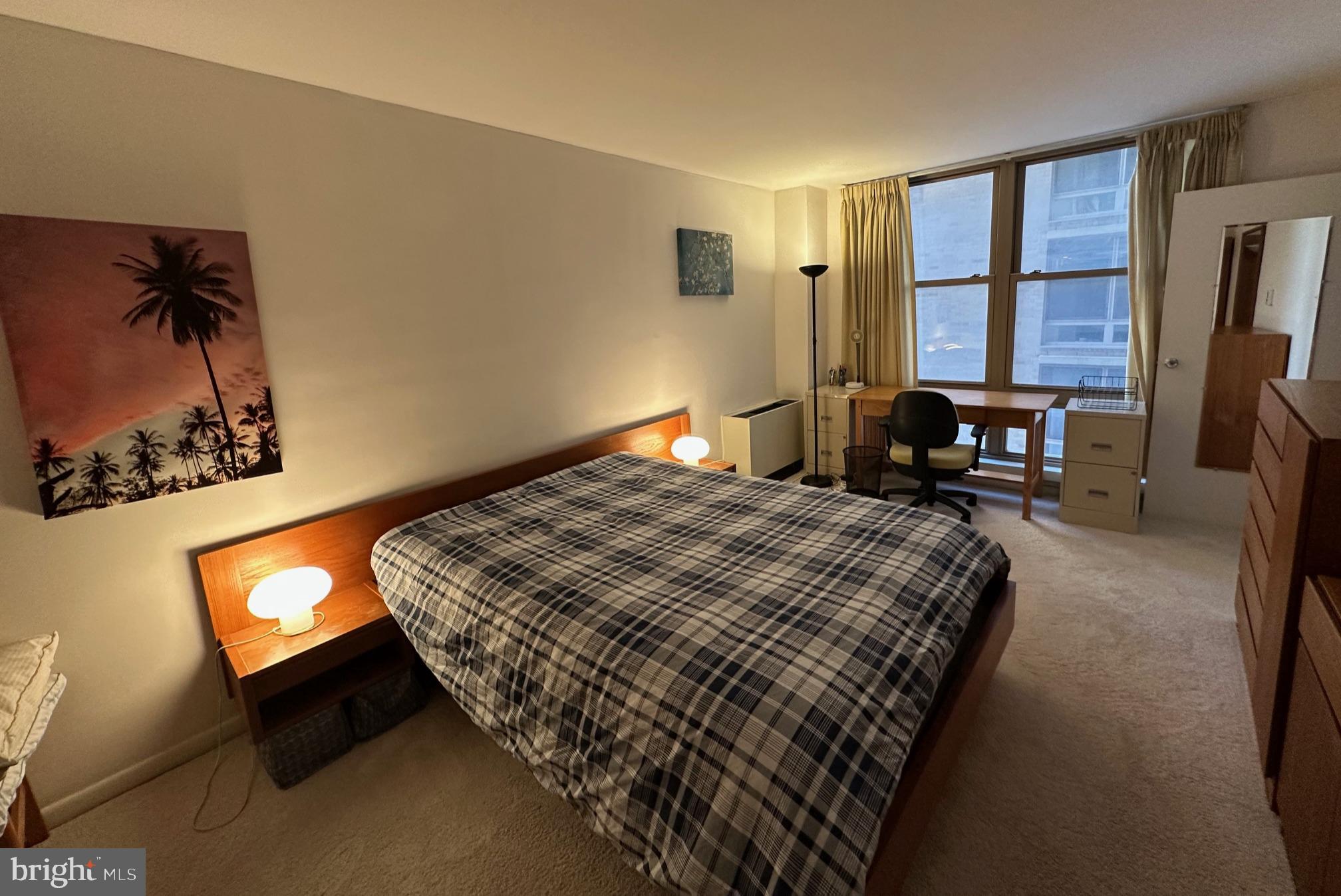 1260 21st Street Northwest, Unit 309 Washington, DC 20036 - Photo 5 of 16 a bed sitting in a bedroom next to a window