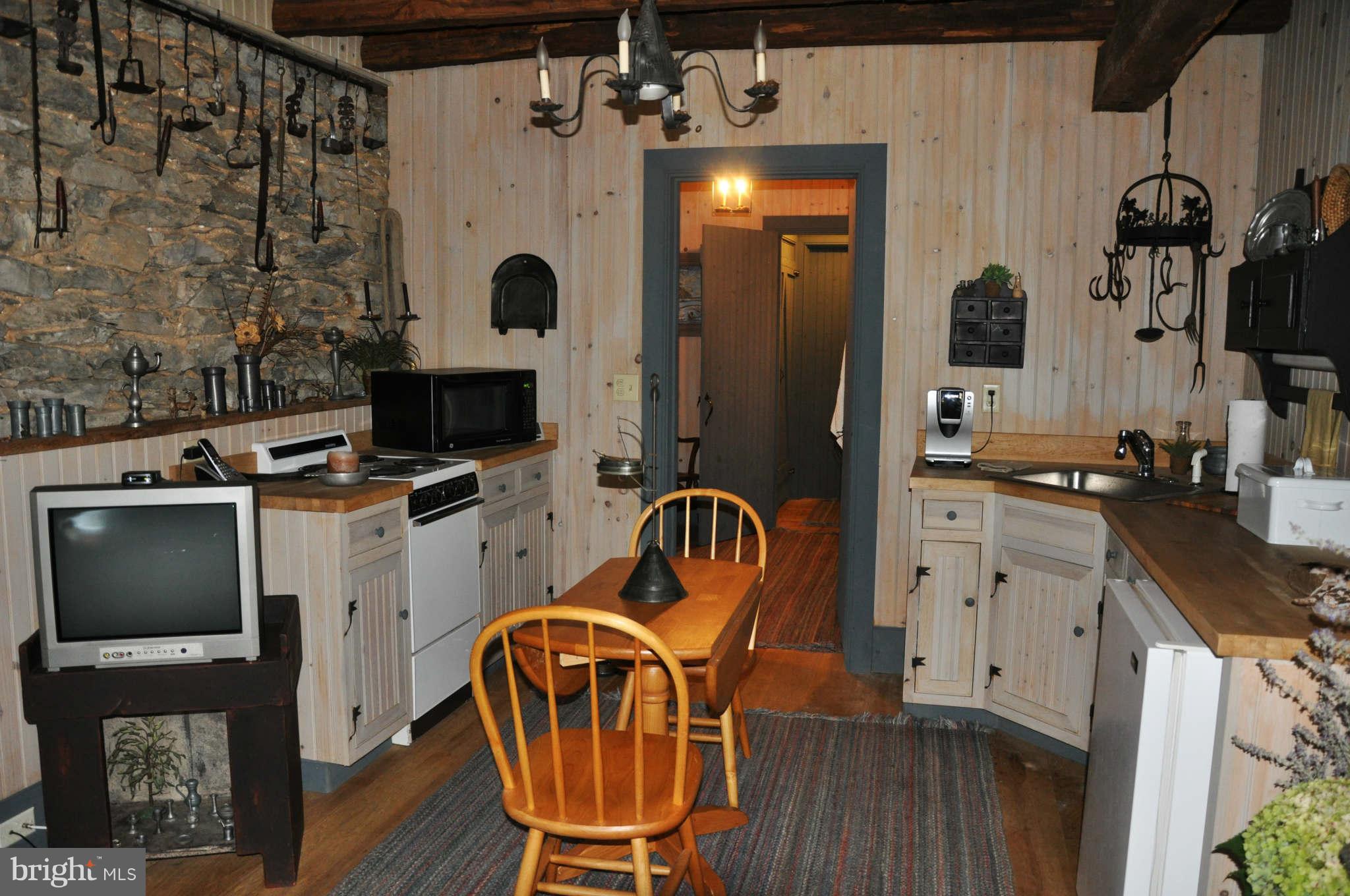 2985 Summit Point Road Summit Point, WV 25446 - Photo 12 of 30 a kitchen with stainless steel appliances granite countertop a stove a sink and a refrigerator