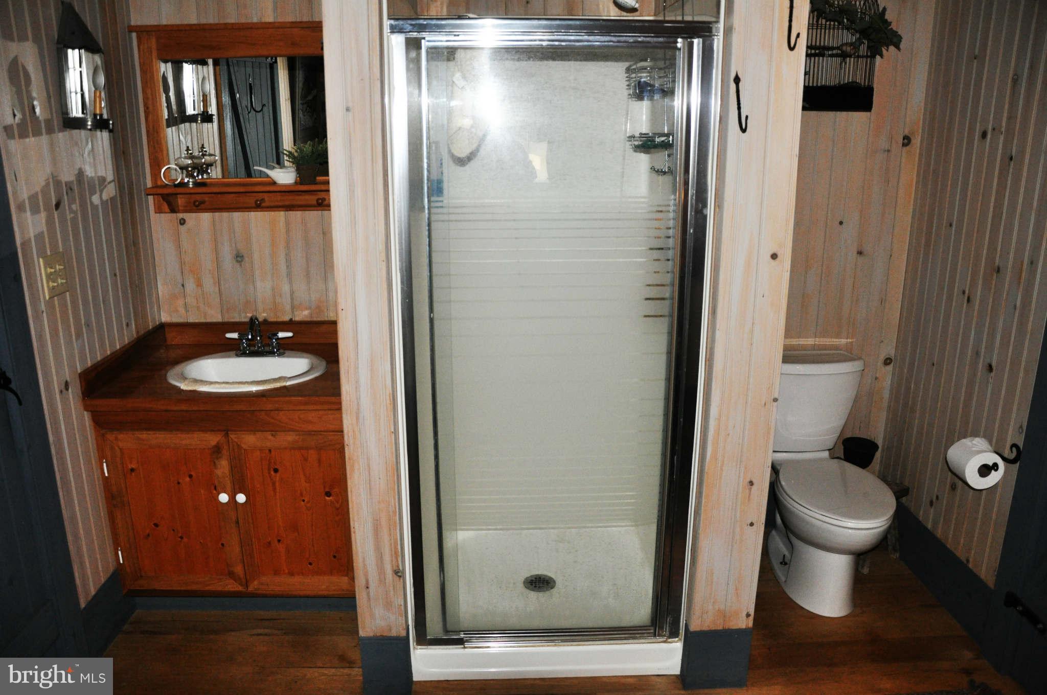 2985 Summit Point Road Summit Point, WV 25446 - Photo 28 of 30 a bathroom with a granite countertop sink toilet and shower
