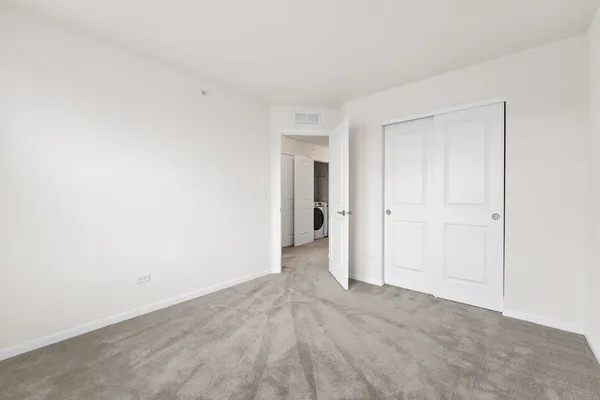 a view of an empty room and closet area