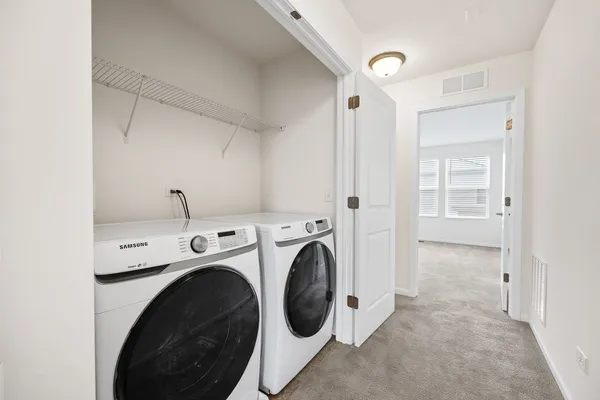 a view of storage and utility room with washer and dryer