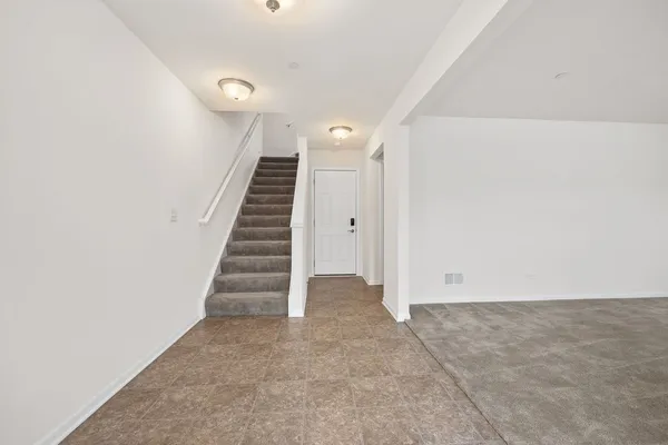 a view of an empty room with stairs