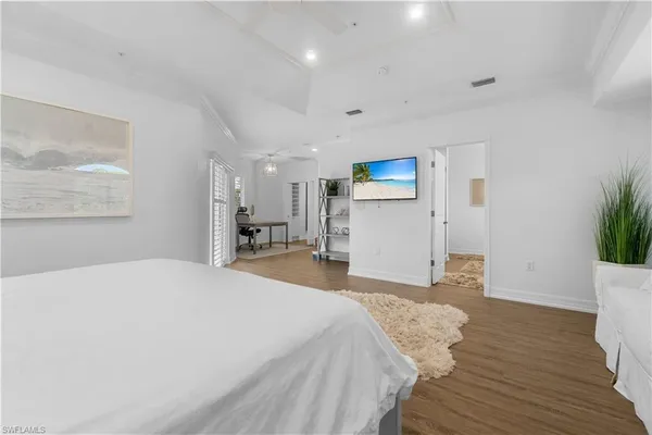 a bedroom with a bed and a potted plant