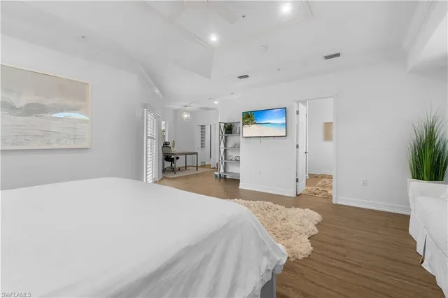 a bedroom with a bed and a potted plant