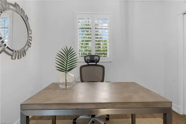 a view of table room with a potted plant and wooden floor