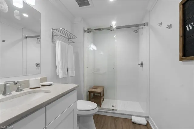 a bathroom with a granite countertop sink toilet and shower