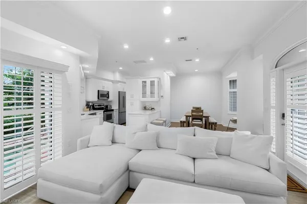 a living room with furniture and view of kitchen