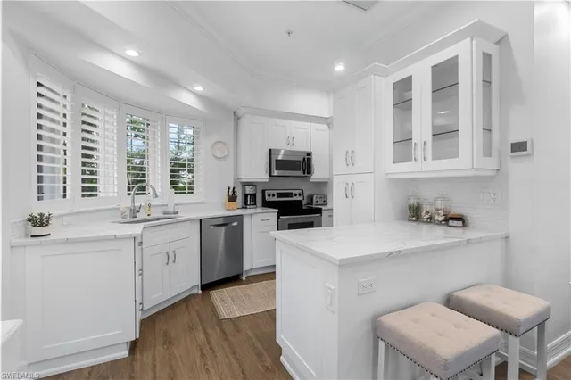 a kitchen with a sink cabinets and wooden floor