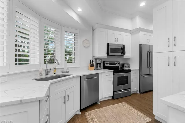 a kitchen with a sink stove and refrigerator