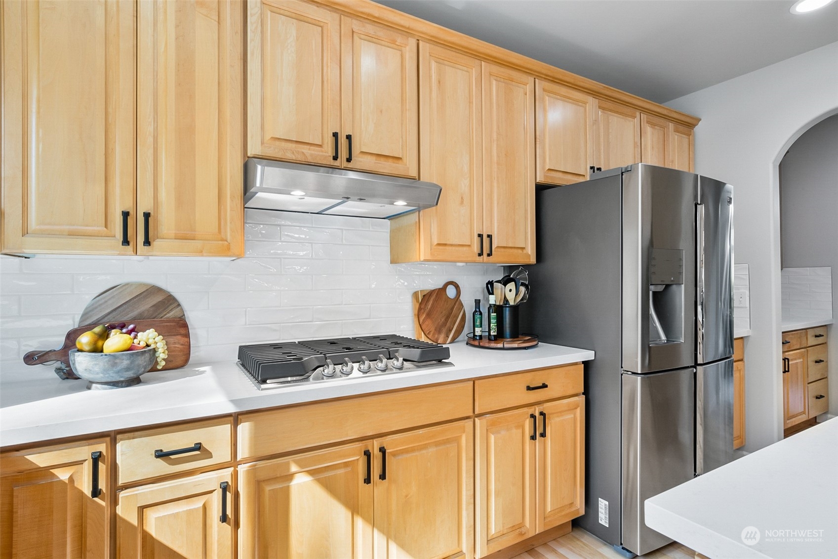 2732 233rd Place Southeast Bothell, WA 98021 - Photo 11 of 40 a kitchen with stainless steel appliances granite countertop a refrigerator sink and white cabinets